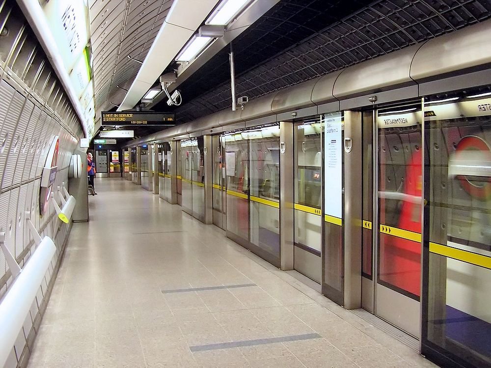 Leeg perron van de London Underground met veiligheidsdeuren van glas en digitale trein aankomstweergave