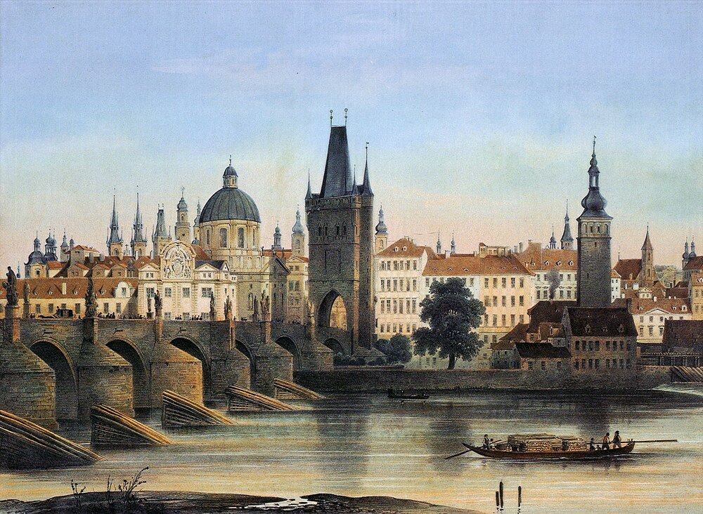 Historisch Europees stadsgezicht met stenen brug, rivier en middeleeuwse torens onder een heldere hemel
