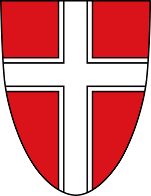 Rood schild met wit dubbelomrand kruis embleem Rood schild met een wit dubbelomrand kruis symbool, dat een heraldisch embleem of wapenontwerp vertegenwoordigt.