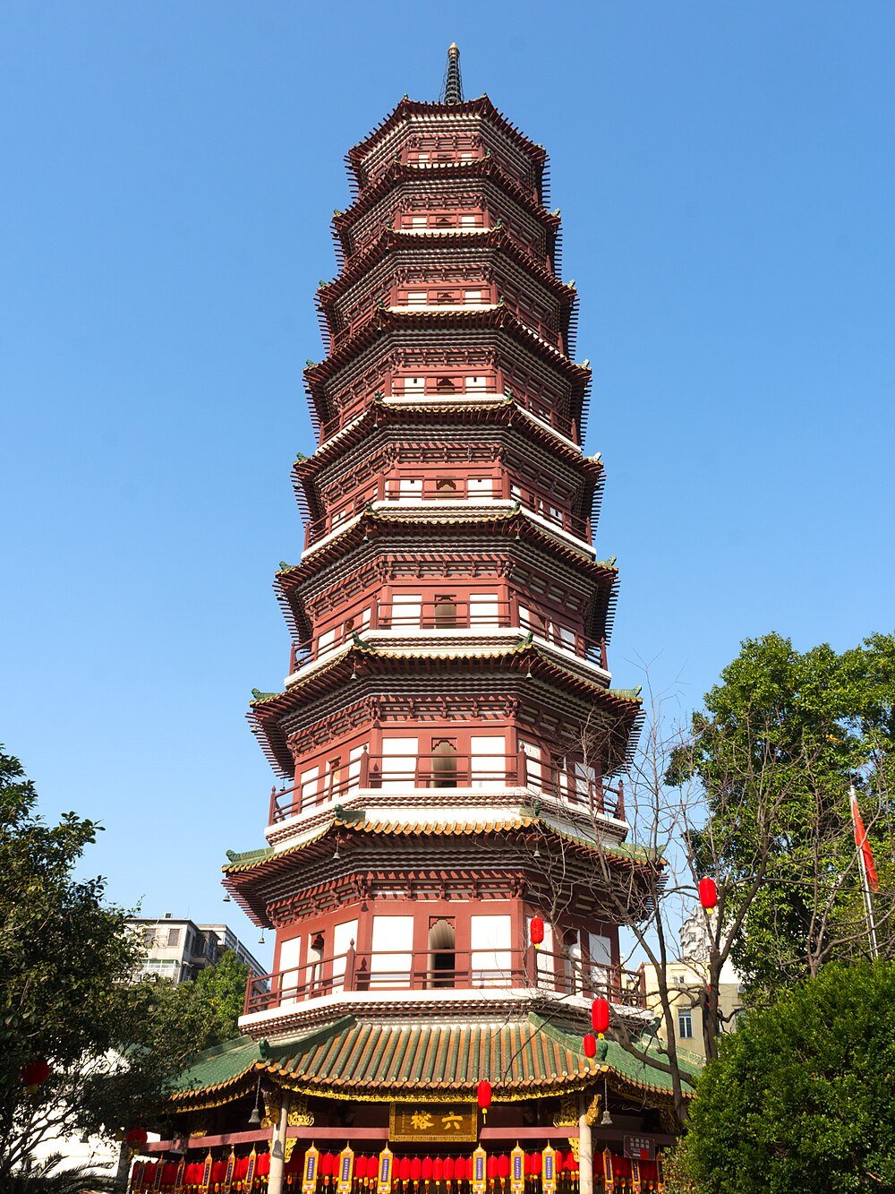 Traditionele Chinese pagodetoren met meerdere niveaus en sierlijke dakdetails onder een heldere blauwe lucht