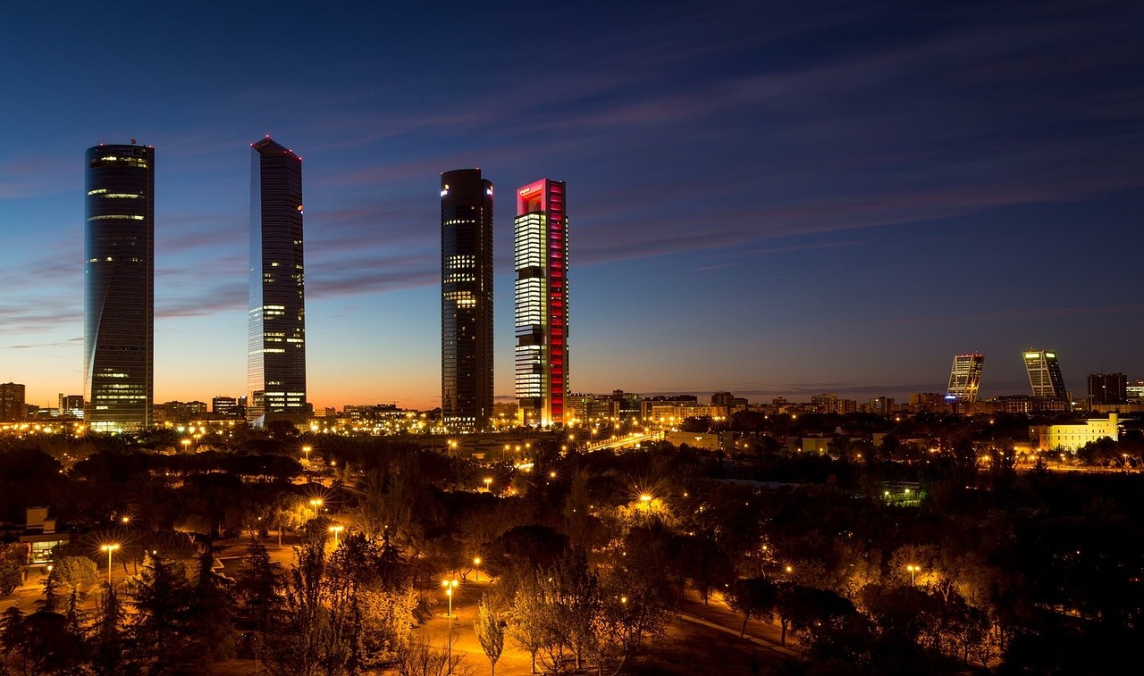 Madrid Cuatro Torres Zakendistrict 's Nachts Nachtelijke skyline van Madrid met verlicht Cuatro Torres zakendistrict en moderne wolkenkrabbers bij schemering